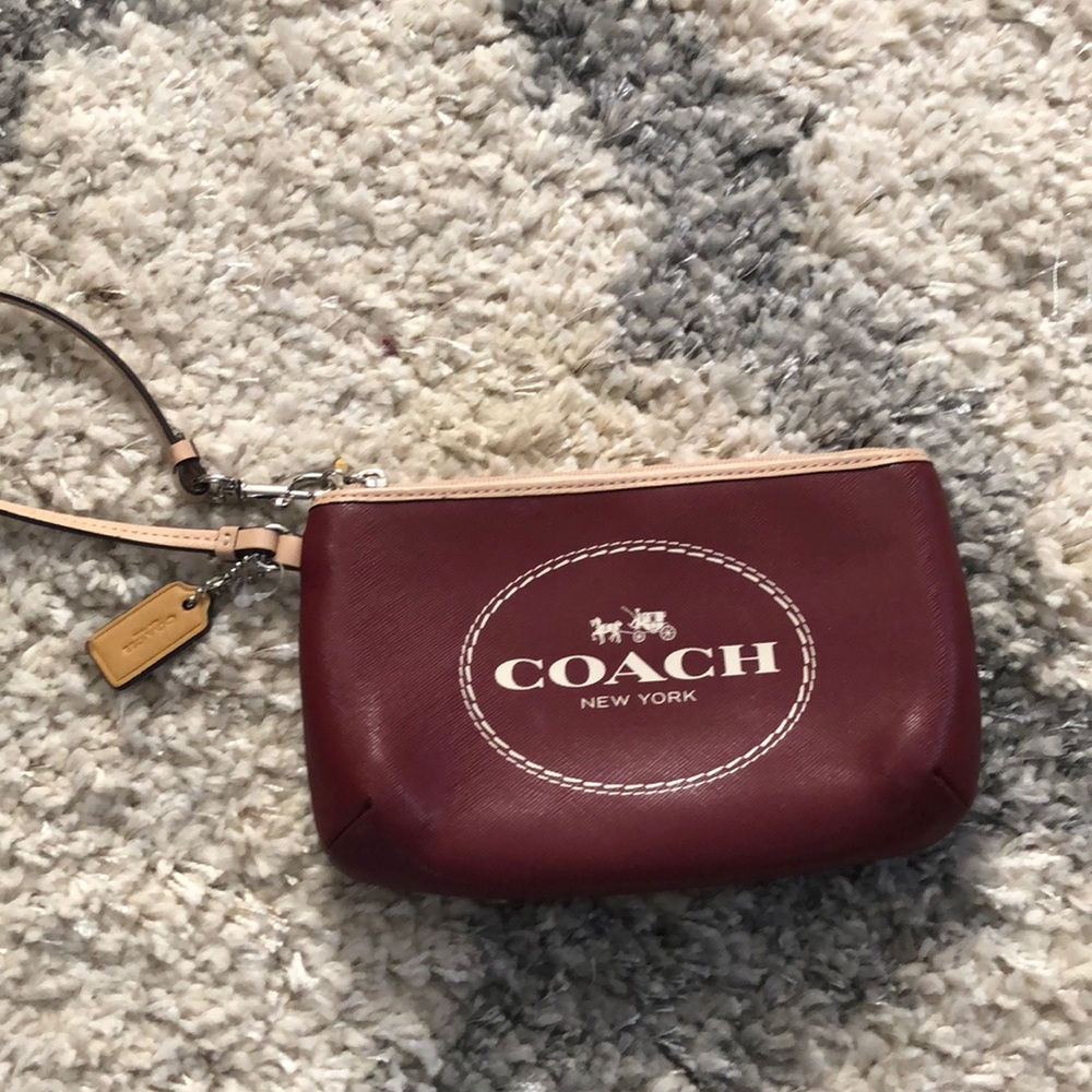 Tan and maroon Coach wristlet